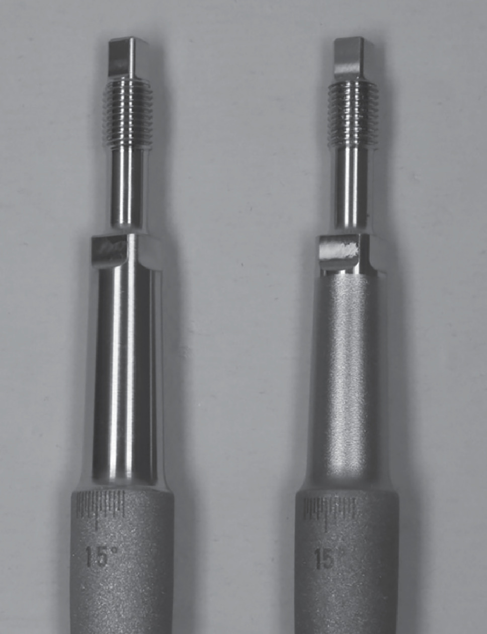 Fig. 2 
          Comparison of the original (left) and current (right) design of the modular taper of the distal implant. After the shot-blasting process for surface hardening, the polished taper has a matte surface. Via the thread, the tension nut can apply tensional forces on the modular connection.
        