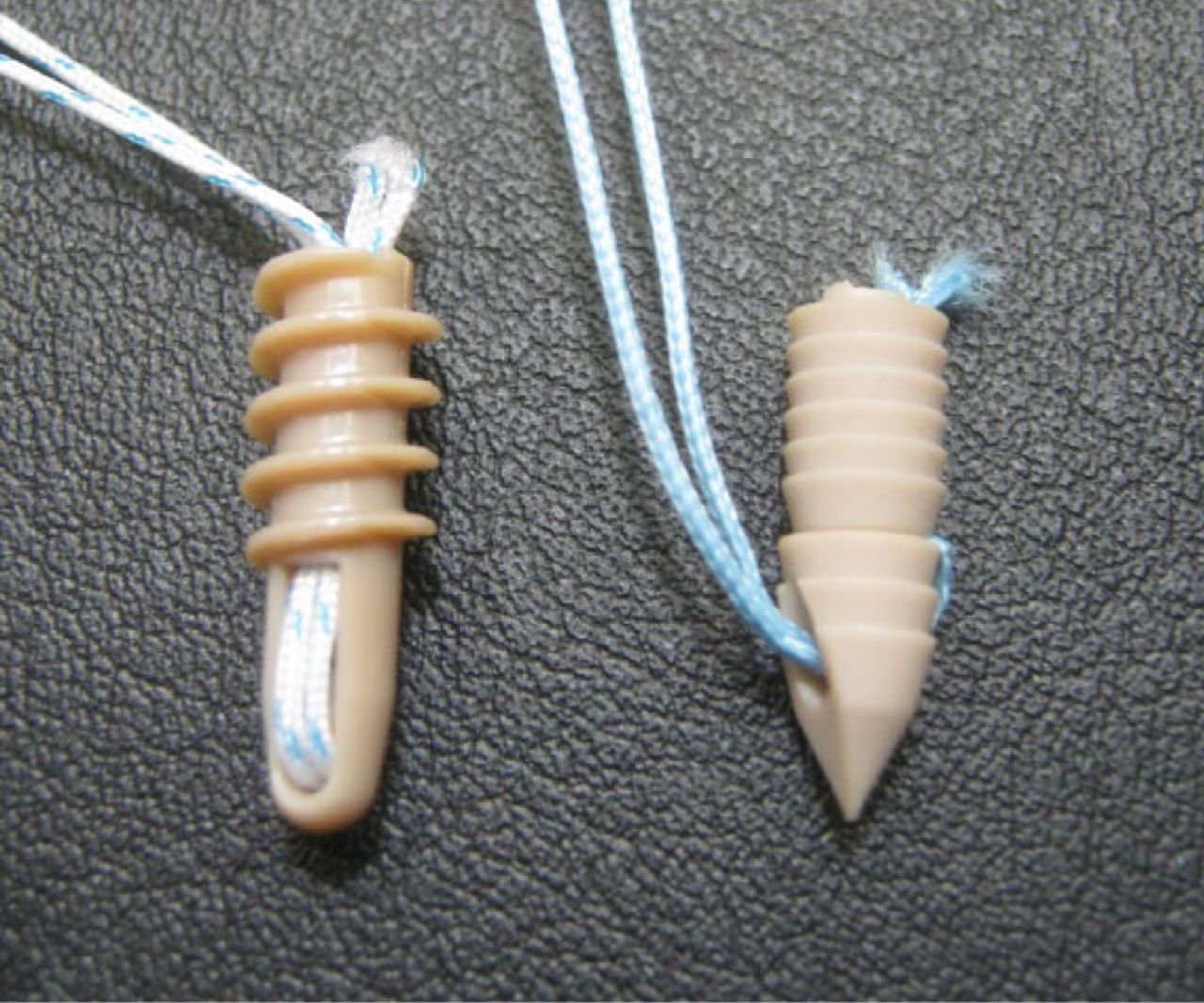 Fig. 1 
          Two major designs of knotless suture anchors according to the way the sutures are handled with respect to the anchor body: (left) internal knotless suture anchor (e.g. SpeedScrew anchor), (right) external knotless suture anchor (e.g. MultiFIX P anchor).
        