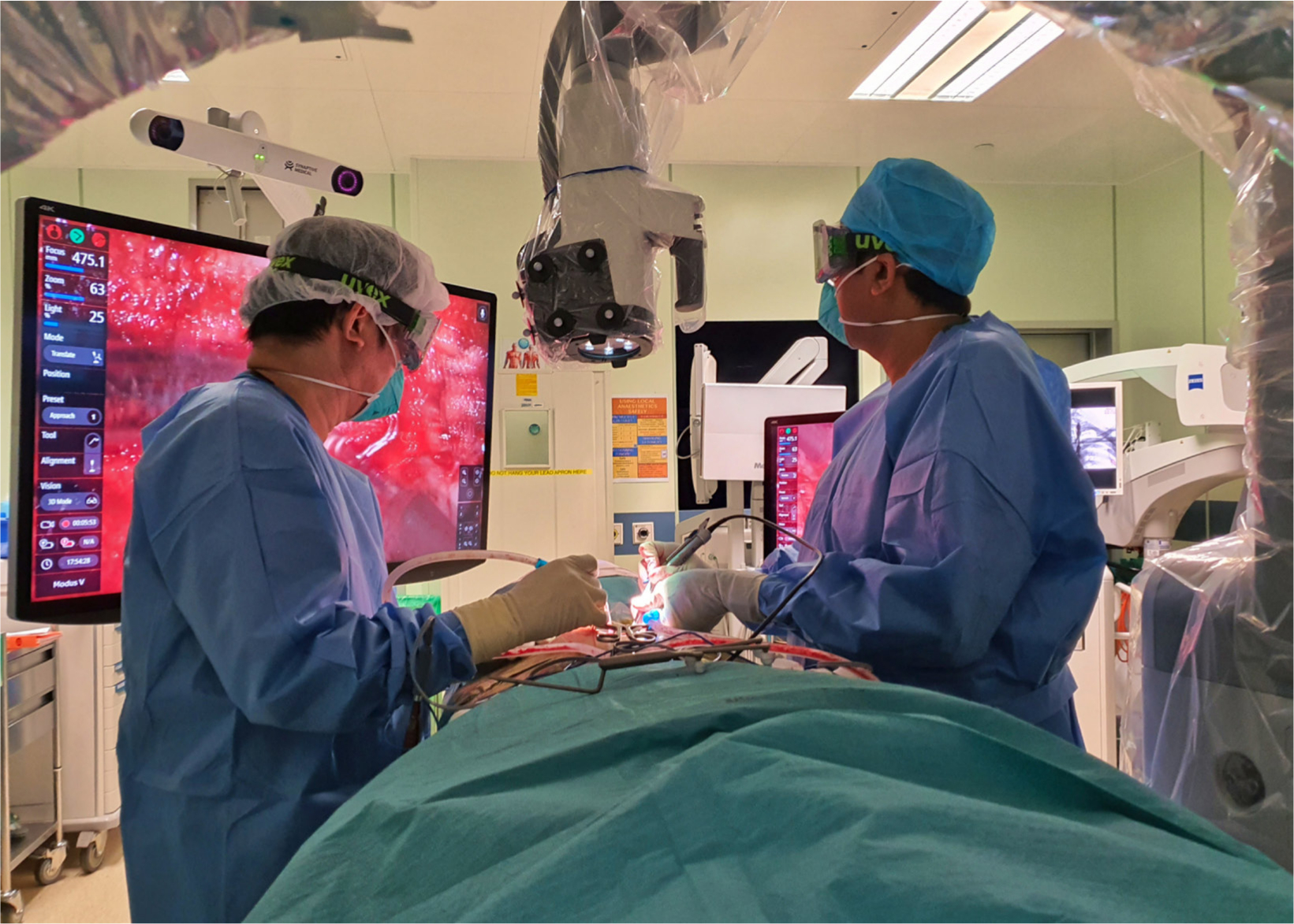 Fig. 4 
        Operating room with exoscope and monitor during a procedure.
      