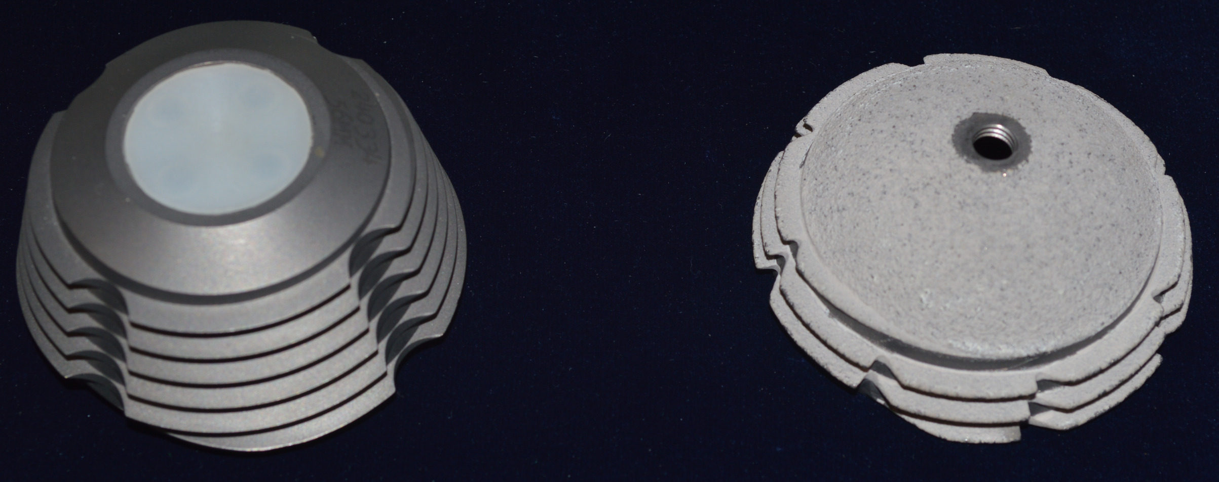 Fig. 2 
          Photograph of the first- (left) and second- (right) generation T-Tap and T-Tap ST acetabular components. The second-generation T-Tap is a fully porous coated hemisphere with threads.
        