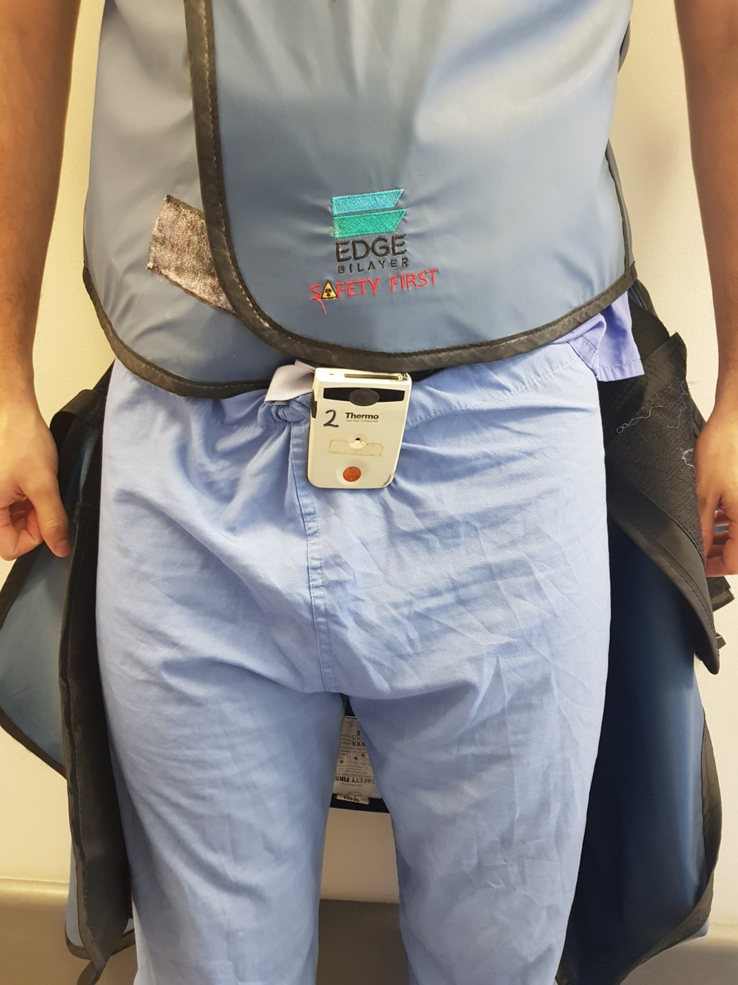 Fig. 2 
          Position of electronic personal dosimeter (EPD) 2 during seated procedures. Lead skirt placed over EPD.
        